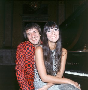 American singer Salvatore Philip Bono, known as Sonny, poses smiling with the singer Cherilyn Sarkisian LaPierre, known as Cher; Sonny wears a flashy, optycal-style red and black outfit, while Cher exhibits a silvery, lamé dress with sequins. Italy, 1966. (Photo by Marcello Salustri/Mondadori via Getty Images)