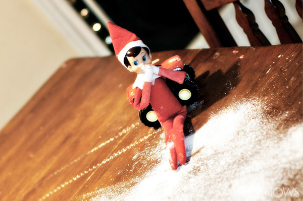 Elf on the Shelf idea 3: Elfie Rojo making snow angels